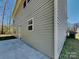 Exterior corner view of the house with siding, concrete patio, and yard at 600 Hunley St, Monroe, NC 28112