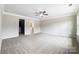 A spacious bedroom with a large closet, an adjacent bathroom, and neutral carpeting at 6084 Diamond Pl, Harrisburg, NC 28075