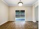 Bright dining area with tiled floor, sliding glass door and backyard view at 6084 Diamond Pl, Harrisburg, NC 28075
