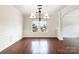 Formal dining room with hardwood floors, wainscoting, and decorative lighting at 6084 Diamond Pl, Harrisburg, NC 28075