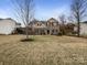 Traditional two-story brick home with black shutters and manicured lawn at 6084 Diamond Pl, Harrisburg, NC 28075