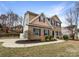 Brick two-story home with manicured landscaping, well-maintained lawn and a paved walkway at 6084 Diamond Pl, Harrisburg, NC 28075
