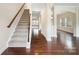 Inviting foyer with hardwood floors, staircase, and archways leading to other rooms at 6084 Diamond Pl, Harrisburg, NC 28075