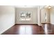 Bright living room with hardwood floors, large windows, and an open layout at 6084 Diamond Pl, Harrisburg, NC 28075