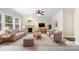Bright, staged living room with fireplace, soft neutral tones, and ceiling fan at 6084 Diamond Pl, Harrisburg, NC 28075