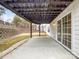 Back patio featuring a pergola, access to the backyard and retaining wall at 6084 Diamond Pl, Harrisburg, NC 28075