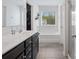 Bright bathroom featuring double vanity, soaking tub under a window, and a walk-in shower at 629 Gants Rd, York, SC 29745