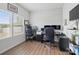 Bright home office with wood floors, multiple monitors, large window, and decorative brick accent wall at 629 Gants Rd, York, SC 29745