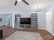 Living room features a built-in entertainment center, luxury vinyl plank flooring, and access to stairs at 629 Gants Rd, York, SC 29745
