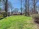 Expansive backyard featuring lush green grass, mature trees, and a storage shed at 638 Forest Ln, Rock Hill, SC 29730