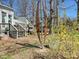 Backyard featuring a sculpture on an a partially green lawn, a deck, and a white painted house at 638 Forest Ln, Rock Hill, SC 29730