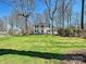 Elegant white home with a large front yard, framed by mature trees under a blue sky at 638 Forest Ln, Rock Hill, SC 29730