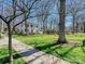 Traditional white house with stately columns, surrounded by a lush lawn and mature trees at 638 Forest Ln, Rock Hill, SC 29730
