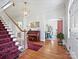 Grand foyer with hardwood floors, a staircase with a red runner and an ornate chandelier at 638 Forest Ln, Rock Hill, SC 29730