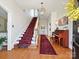 Grand foyer with hardwood floors, a staircase with a red runner and an ornate chandelier at 638 Forest Ln, Rock Hill, SC 29730
