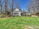 Charming white home with a porte-cochère and a spacious front yard, framed by mature trees at 638 Forest Ln, Rock Hill, SC 29730