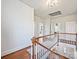 Bright hallway with hardwood floors and white railings leading to the upper level at 638 Forest Ln, Rock Hill, SC 29730