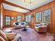 Inviting living room with wood-paneled walls and classic furnishings. Hardwood floors and lots of natural light at 638 Forest Ln, Rock Hill, SC 29730