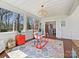 Sunroom features a colorful rug, bright windows, and opens to the dining room at 638 Forest Ln, Rock Hill, SC 29730