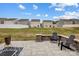 Backyard with a patio area featuring stone accents and lawn with neighboring houses at 638 Nannyberry Ln, Concord, NC 28025