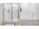 Tidy bathroom features a tub-shower combination with glass door and white fixtures at 638 Nannyberry Ln, Concord, NC 28025