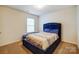 Cozy bedroom with a plush blue bed frame and neutral-toned bedding near a bright window at 638 Nannyberry Ln, Concord, NC 28025