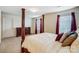Well-lit bedroom features a decorative four-poster bed and ample closet space at 638 Nannyberry Ln, Concord, NC 28025