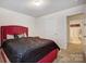 Relaxing bedroom with an upholstered bed, black comforter, and easy access to bathroom at 638 Nannyberry Ln, Concord, NC 28025