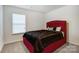 Comfortable bedroom features a large window and a stylish red upholstered bed frame at 638 Nannyberry Ln, Concord, NC 28025