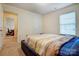 Bedroom with a plush bed and window, leading to an office space with a desk and chair at 638 Nannyberry Ln, Concord, NC 28025