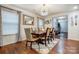 Bright dining room features hardwood floors, modern chandelier, and a decorative mirror at 638 Nannyberry Ln, Concord, NC 28025