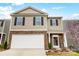 Charming two-story home with a welcoming front yard, brick accents and a two car garage at 638 Nannyberry Ln, Concord, NC 28025