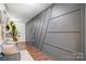 Contemporary foyer with wood floors, custom gray accent wall, and modern decor at 638 Nannyberry Ln, Concord, NC 28025