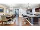 Open concept kitchen with stainless steel appliances, granite counters, pendant lighting, and an adjacent dining area at 638 Nannyberry Ln, Concord, NC 28025