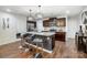 Well-appointed kitchen features dark cabinetry, granite countertops, stainless steel appliances, and stylish pendant lights at 638 Nannyberry Ln, Concord, NC 28025