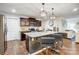 Open kitchen with a large island, barstool seating, granite counters, and seamless flow to living areas at 638 Nannyberry Ln, Concord, NC 28025