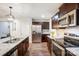 Modern kitchen with stainless steel appliances, a double basin sink, and rich, dark wood cabinets at 638 Nannyberry Ln, Concord, NC 28025