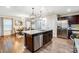 A well-designed kitchen island with seating, stainless steel appliances, and an open view to the dining area at 638 Nannyberry Ln, Concord, NC 28025