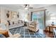 Bright living room with modern decor, plush seating, ceiling fan, and sliding glass doors to an outdoor patio at 638 Nannyberry Ln, Concord, NC 28025