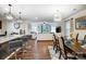 Open concept living and dining area with modern furnishings and stylish lighting fixtures at 638 Nannyberry Ln, Concord, NC 28025