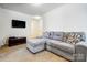 Cozy living room features a comfortable gray sectional sofa and wall-mounted TV at 638 Nannyberry Ln, Concord, NC 28025