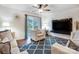 Comfortable living room featuring a modern ceiling fan and a wall-mounted TV at 638 Nannyberry Ln, Concord, NC 28025