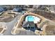 Aerial view of community pool and clubhouse surrounded by townhomes and a parking lot at 6450 Keeton Ln, Harrisburg, NC 28075