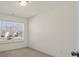 A bedroom featuring neutral carpet, light walls, a window with blinds and a door with silver hardware at 6450 Keeton Ln, Harrisburg, NC 28075