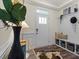 Charming foyer with coat rack and bench, illuminated by natural light at 6450 Keeton Ln, Harrisburg, NC 28075