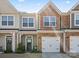 Two-story townhouse with a mix of stone and siding, a garage and well-kept landscaping at 6450 Keeton Ln, Harrisburg, NC 28075