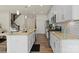 Modern kitchen with stainless steel appliances, light countertops, and bright white cabinetry at 6450 Keeton Ln, Harrisburg, NC 28075