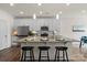 Bright eat-in kitchen with stainless steel appliances, light countertops and breakfast bar seating at 6450 Keeton Ln, Harrisburg, NC 28075