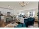Open-plan living room with an island, a cozy seating area, and ample natural light at 6450 Keeton Ln, Harrisburg, NC 28075