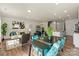 Bright open living room area with a modern dining table, and stainless steel appliances at 6450 Keeton Ln, Harrisburg, NC 28075
